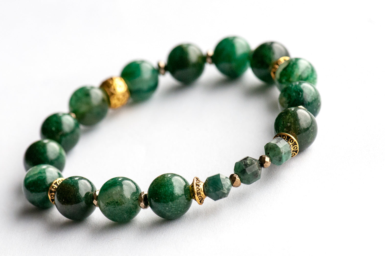 May birthstone bracelet featuring green gemstones: emerald, mica, green strawberry quartz, and moss agate, with gold hematite and gold plated accent beads. Handmade in New Brunswick Canada