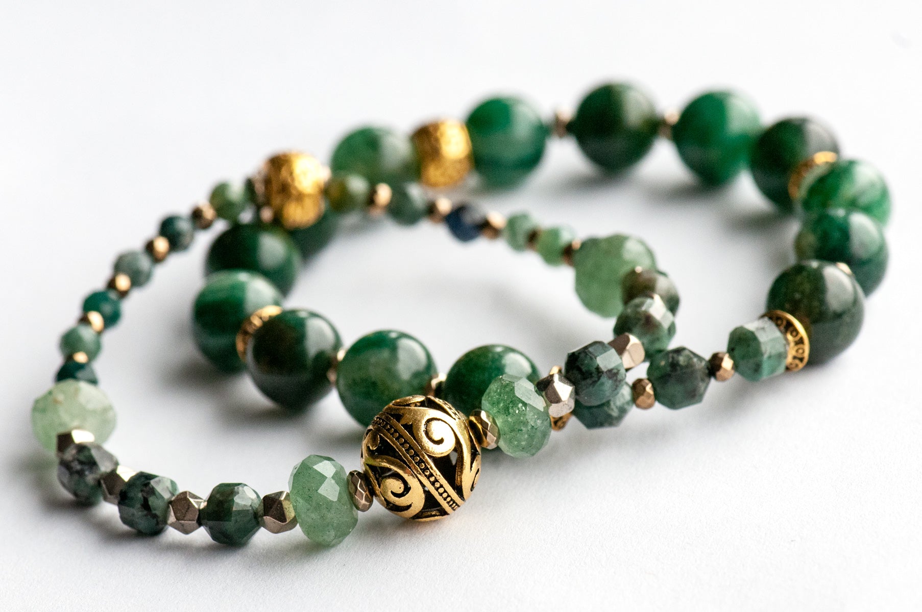May birthstone bracelet featuring green gemstones: emerald, mica, green strawberry quartz, and moss agate, with gold hematite and gold plated accent beads. Handmade in New Brunswick Canada