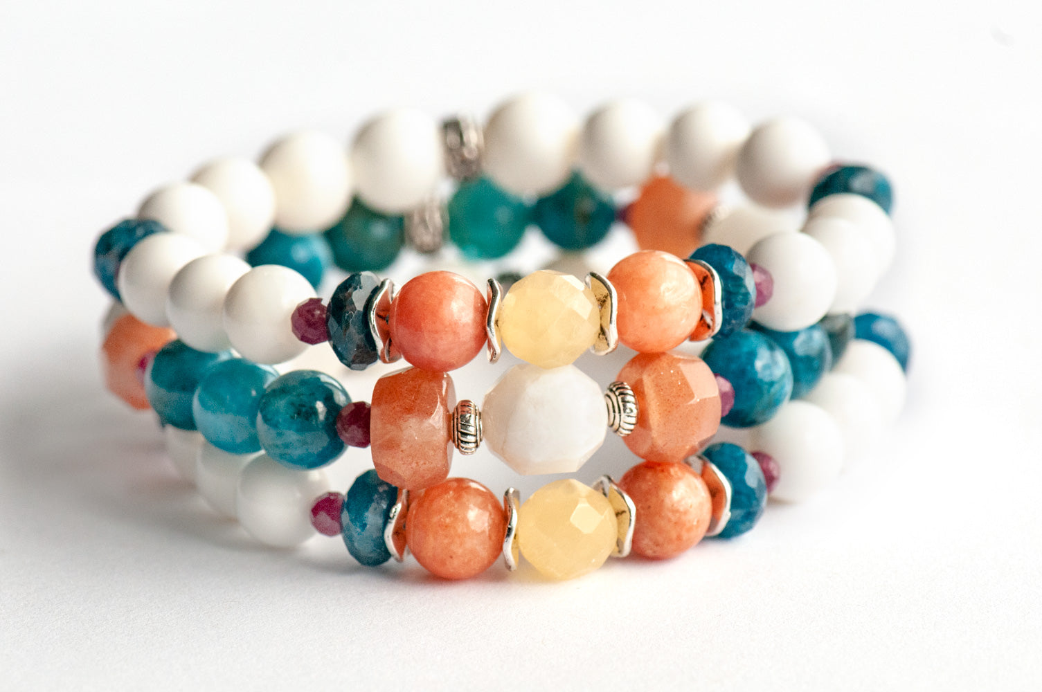 Fierce Radiance bracelet set with blue apatite, orange Calcite, yellow Jade, plum tourmaline, and golden sunstone with white shell beads handmade in New Brunswick Canada