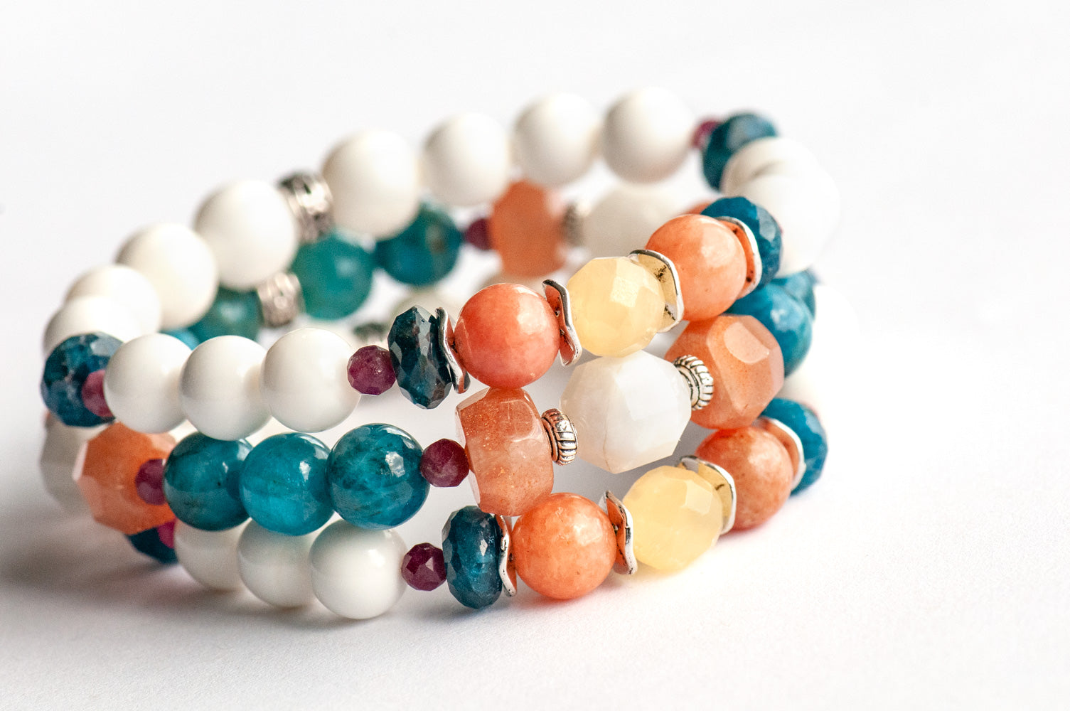Fierce Radiance bracelet set with blue apatite, orange Calcite, yellow Jade, plum tourmaline, and golden sunstone with white shell beads handmade in New Brunswick Canada