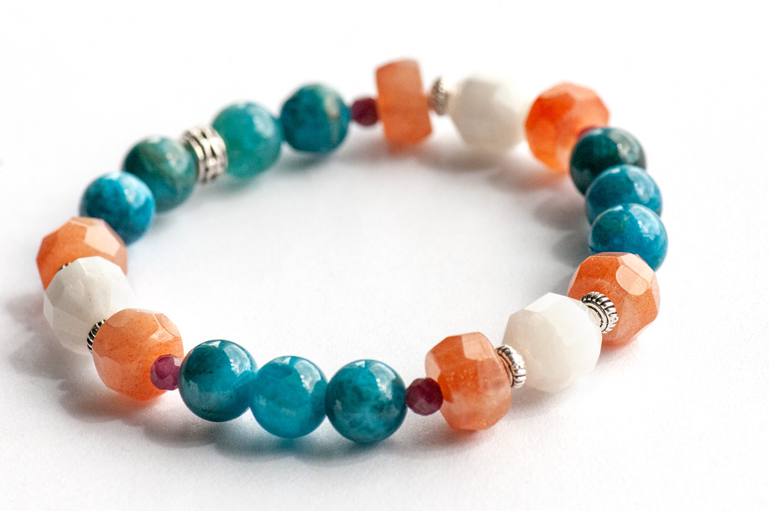 Fierce Radiance bracelet set with blue apatite, orange Calcite, yellow Jade, plum tourmaline, and golden sunstone with white shell beads handmade in New Brunswick Canada