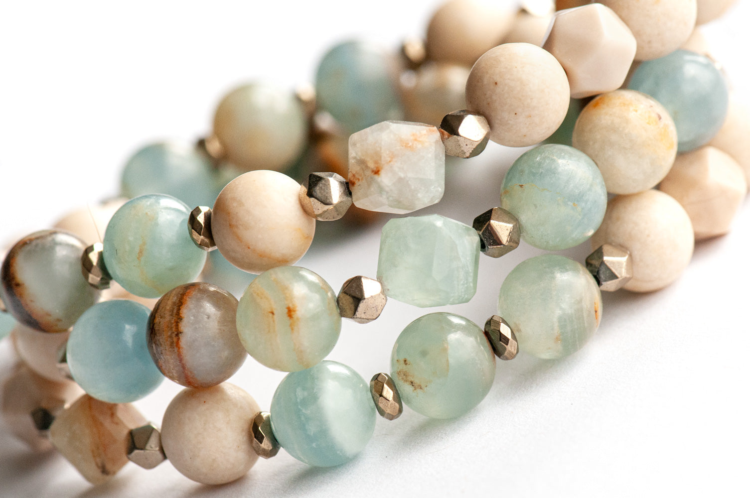 Sandy Shores mala-style triple wrap bracelet with Lemurian Aquitaine Calcite and petrified wood beads in soothing soft blues and beiges