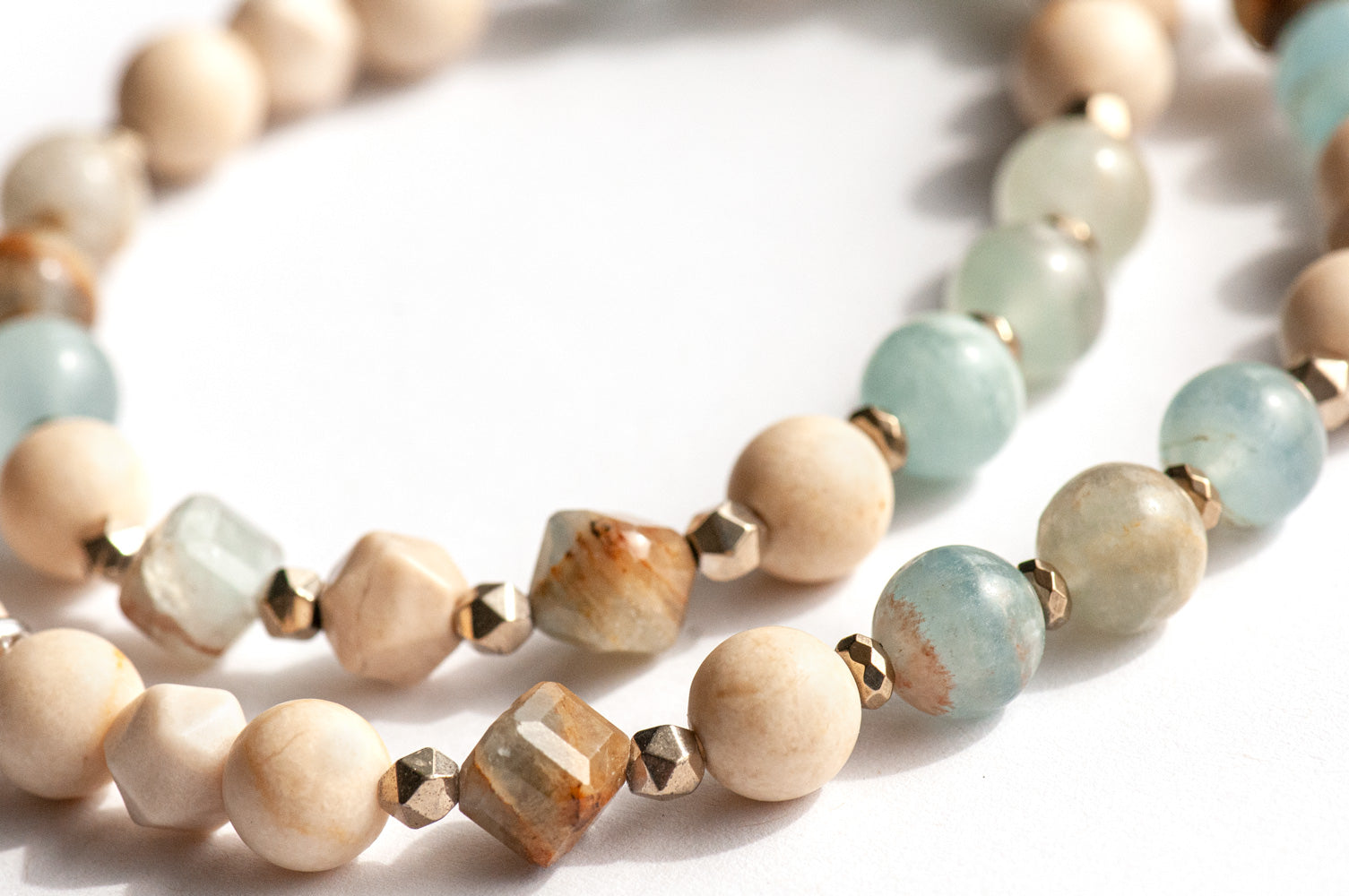 Sandy Shores mala-style triple wrap bracelet with Lemurian Aquitaine Calcite and petrified wood beads in soothing soft blues and beiges
