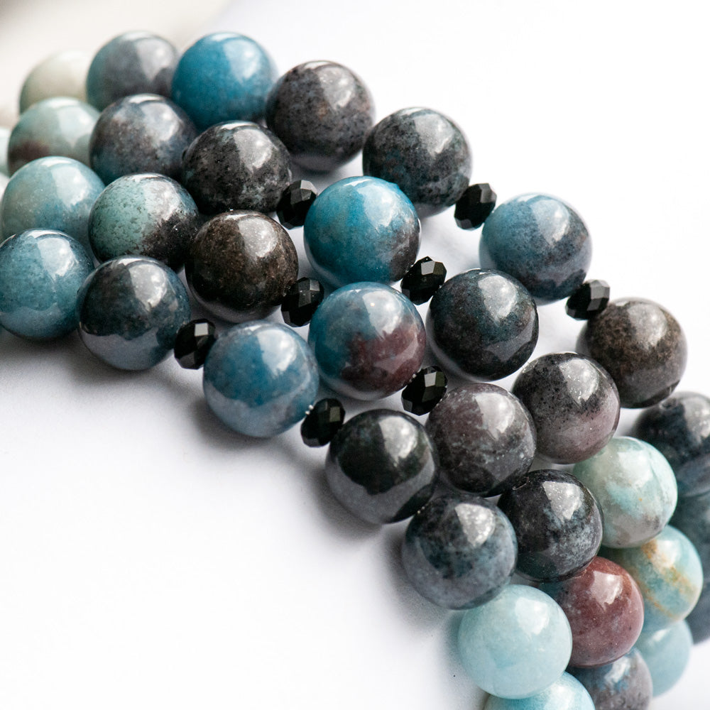Single strand blue ombre Trolleite bracelet with black onyx accent beads and white Jade, handmade in New Brunswick Canada