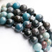 Single strand blue ombre Trolleite bracelet with black onyx accent beads and white Jade, handmade in New Brunswick Canada