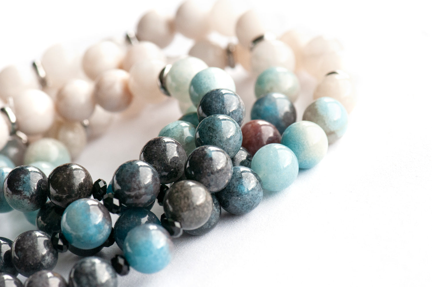 Single strand blue ombre Trolleite bracelet with black onyx accent beads and white Jade, handmade in New Brunswick Canada
