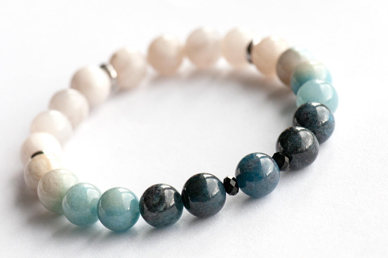 Single strand blue ombre Trolleite bracelet with black onyx accent beads and white Jade, handmade in New Brunswick Canada