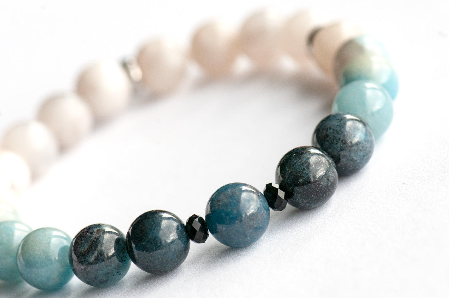 Single strand blue ombre Trolleite bracelet with black onyx accent beads and white Jade, handmade in New Brunswick Canada