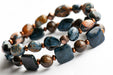 The Deep Cove bracelet duo combines the swirling colours of pietersite pebbles with bronzite and copper-plated hematite with deep blue Dumortierite squares. 
