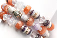 Sunstone, lavender amethyst, sugilite, and stunning wampum shell beads combine in this orange and purple handmade bracelet set. 