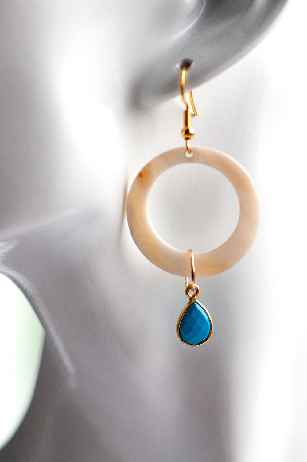 have your hoop and dangle too. carved shell rings dangle from gold plated hooks while turquoise howlite bezels dangle from the hoops
