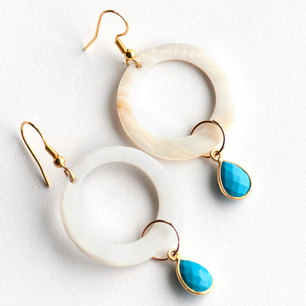 have your hoop and dangle too. carved shell rings dangle from gold plated hooks while turquoise howlite bezels dangle from the hoops