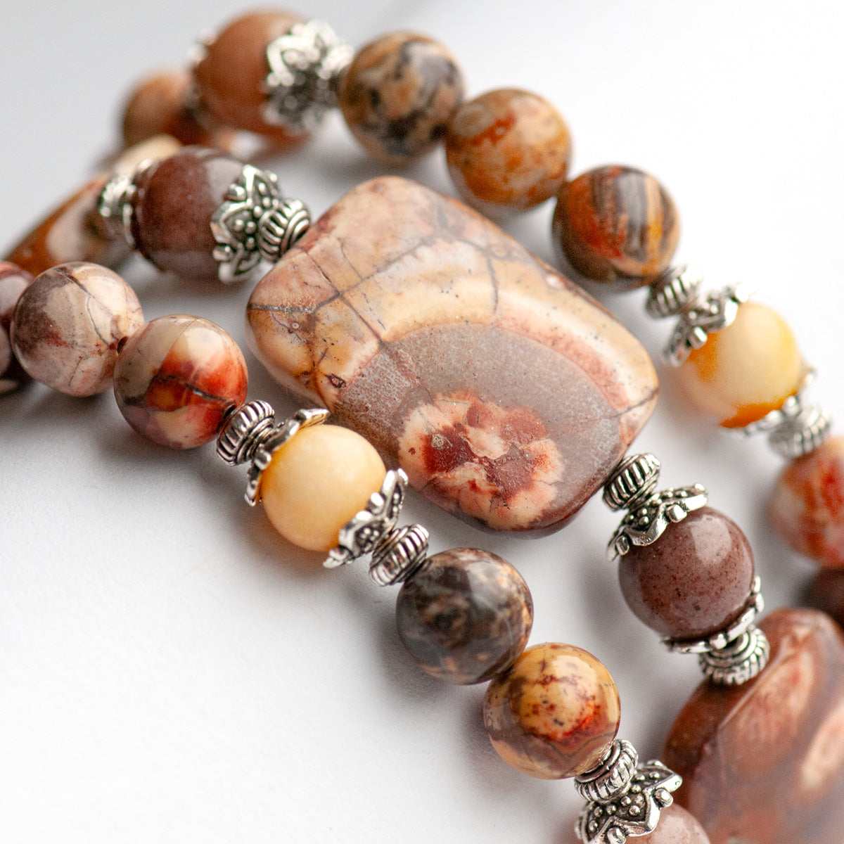 'The Enchanted Forest Trio' – a handcrafted bracelet set with Birds Eye Rhyolite, yellow Burmese Jade & purple aventurine