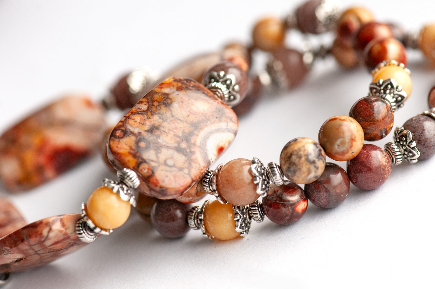 'The Enchanted Forest Trio' – a handcrafted bracelet set with Birds Eye Rhyolite, yellow Burmese Jade & purple aventurine