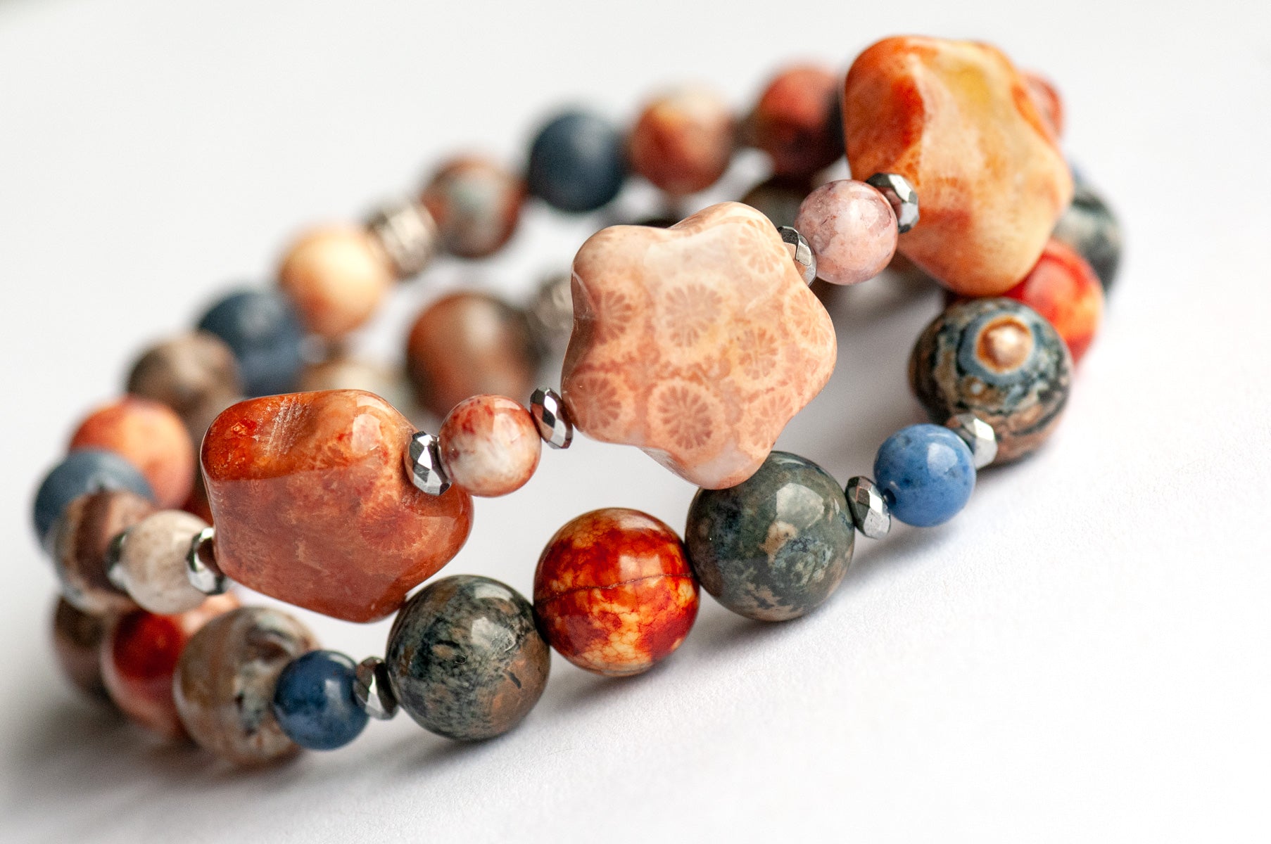 Handmade gemstone bracelet set of two featuring fossil coral, agate, hematite, and dumortierite 
