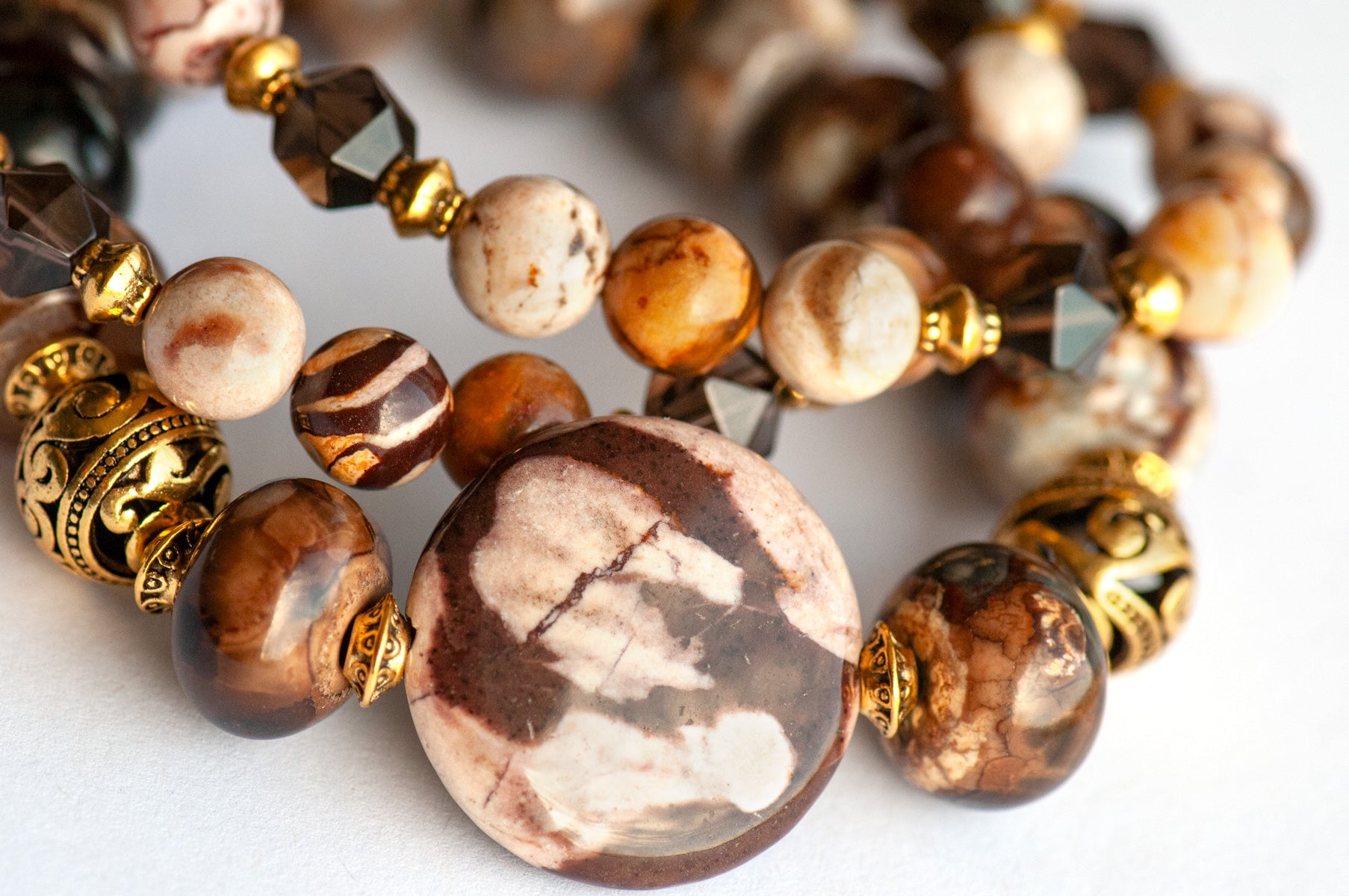 Smoky Quartz and Botswana Agate handmade bracelet set with golden accents. 