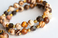 Smoky Quartz and Botswana Agate handmade bracelet set with golden accents. 