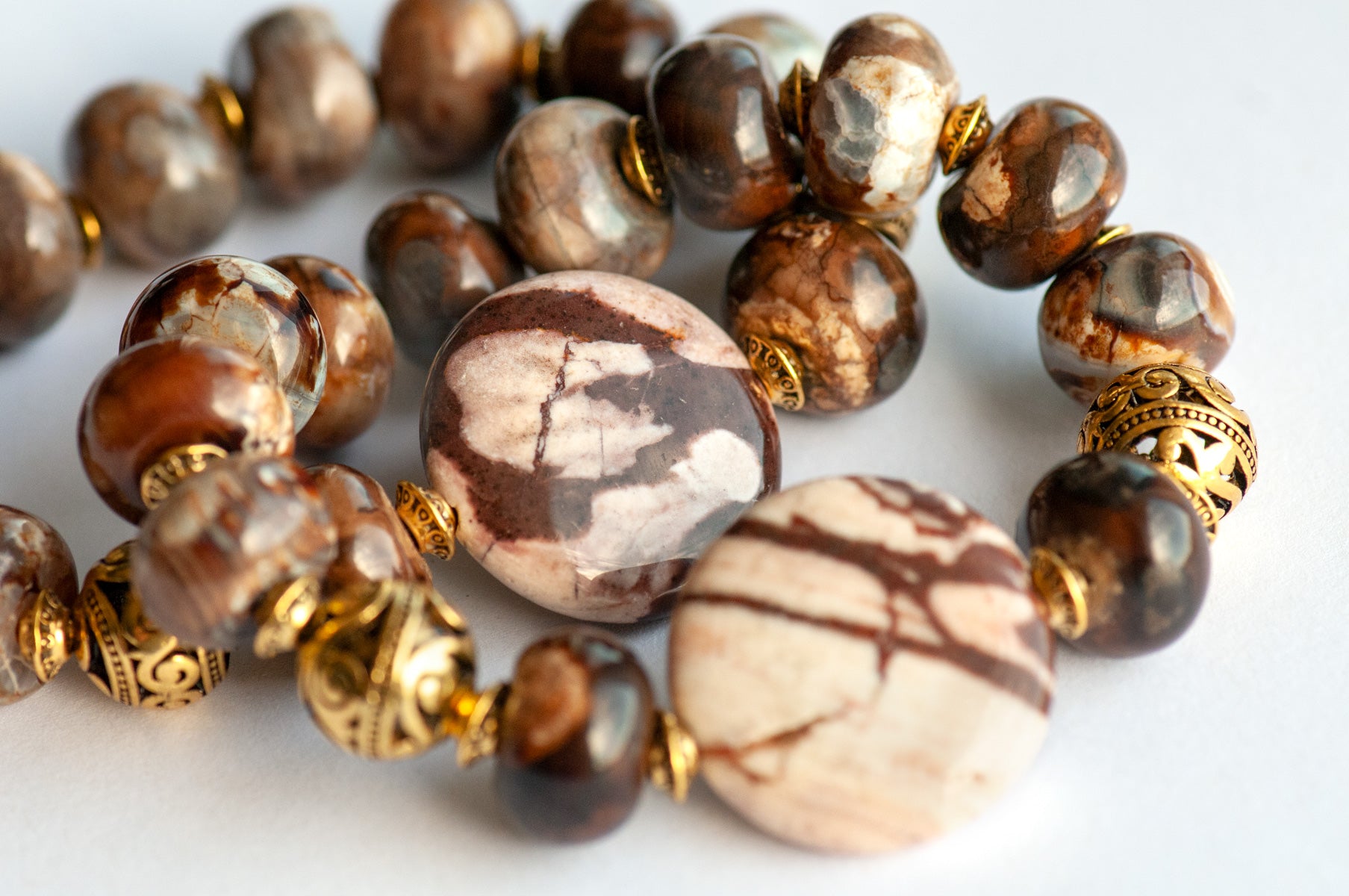 Smoky Quartz and Botswana Agate handmade bracelet set with golden accents. 