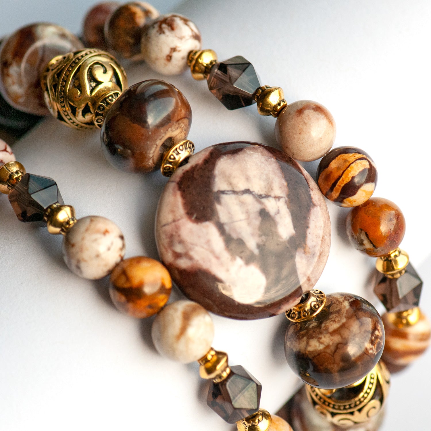 Smoky Quartz and Botswana Agate handmade bracelet set with golden accents. 