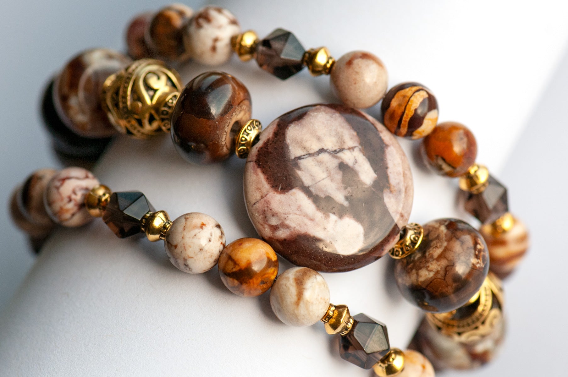 Smoky Quartz and Botswana Agate handmade bracelet set with golden accents. 