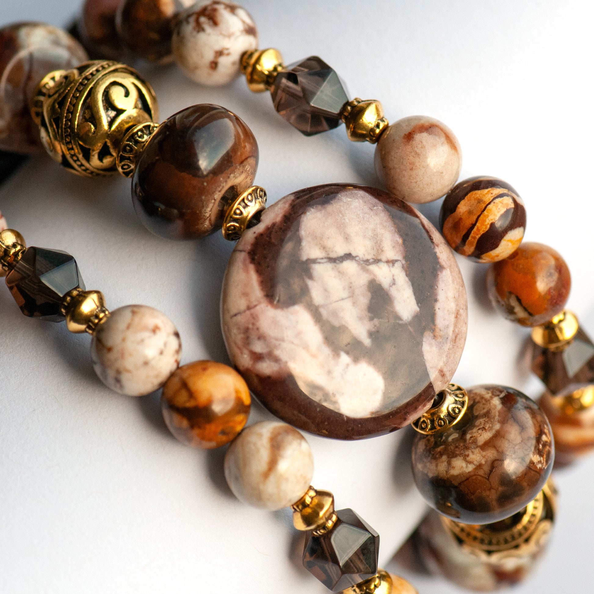 Smoky Quartz and Botswana Agate handmade bracelet set with golden accents. 