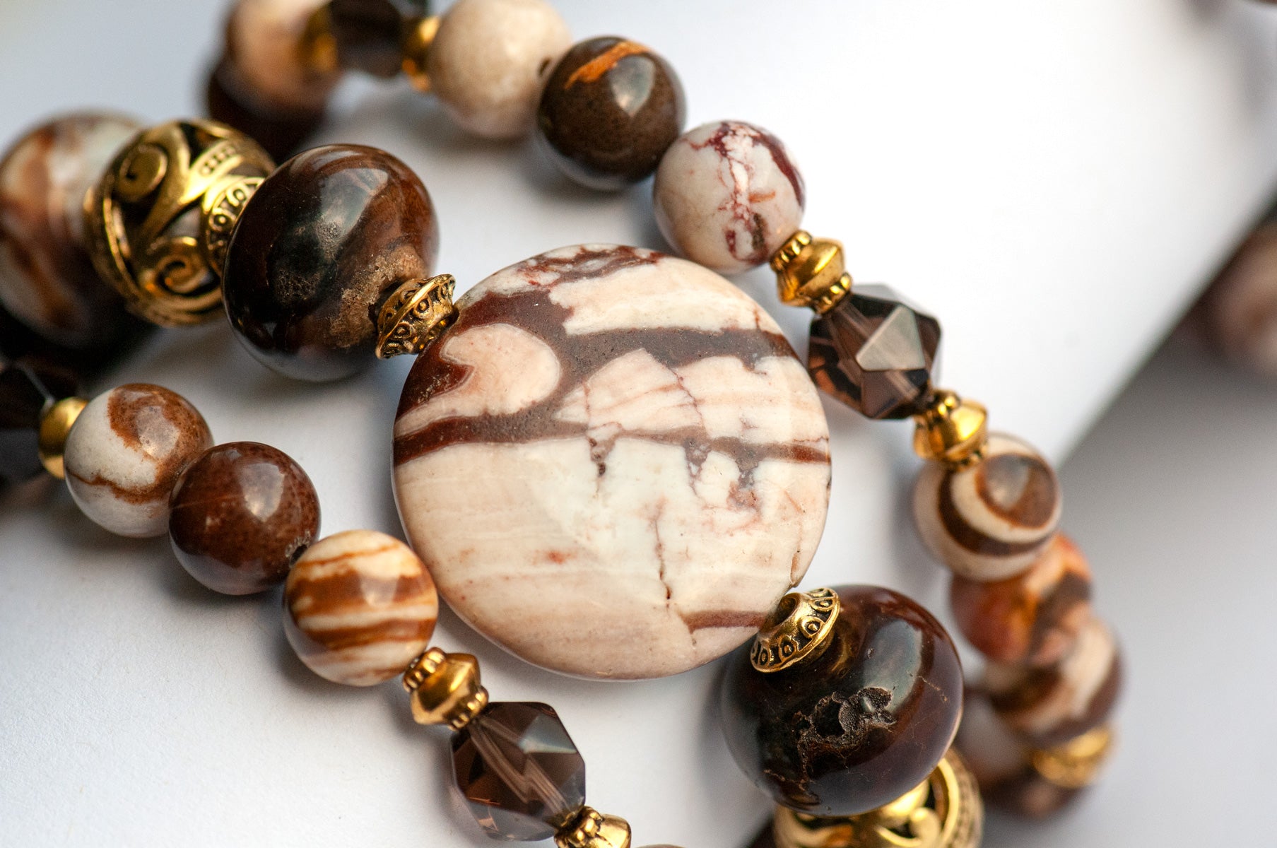 Smoky Quartz and Botswana Agate handmade bracelet set with golden accents. 