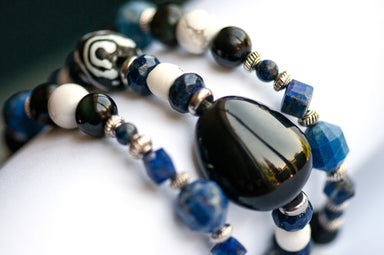 Rainbow Obsidian, howlite, lapis, and recycled glass beads in handmade protection bracelet