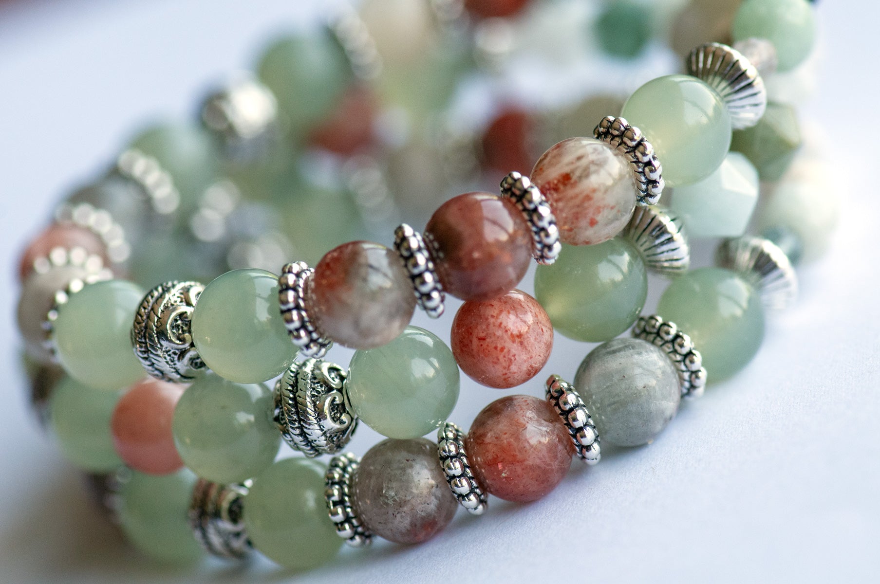The Fierce Acceptance bracelet set is handmade with Jade, Arusha Sunstone, and Sepentine in calming shades of green and orange.