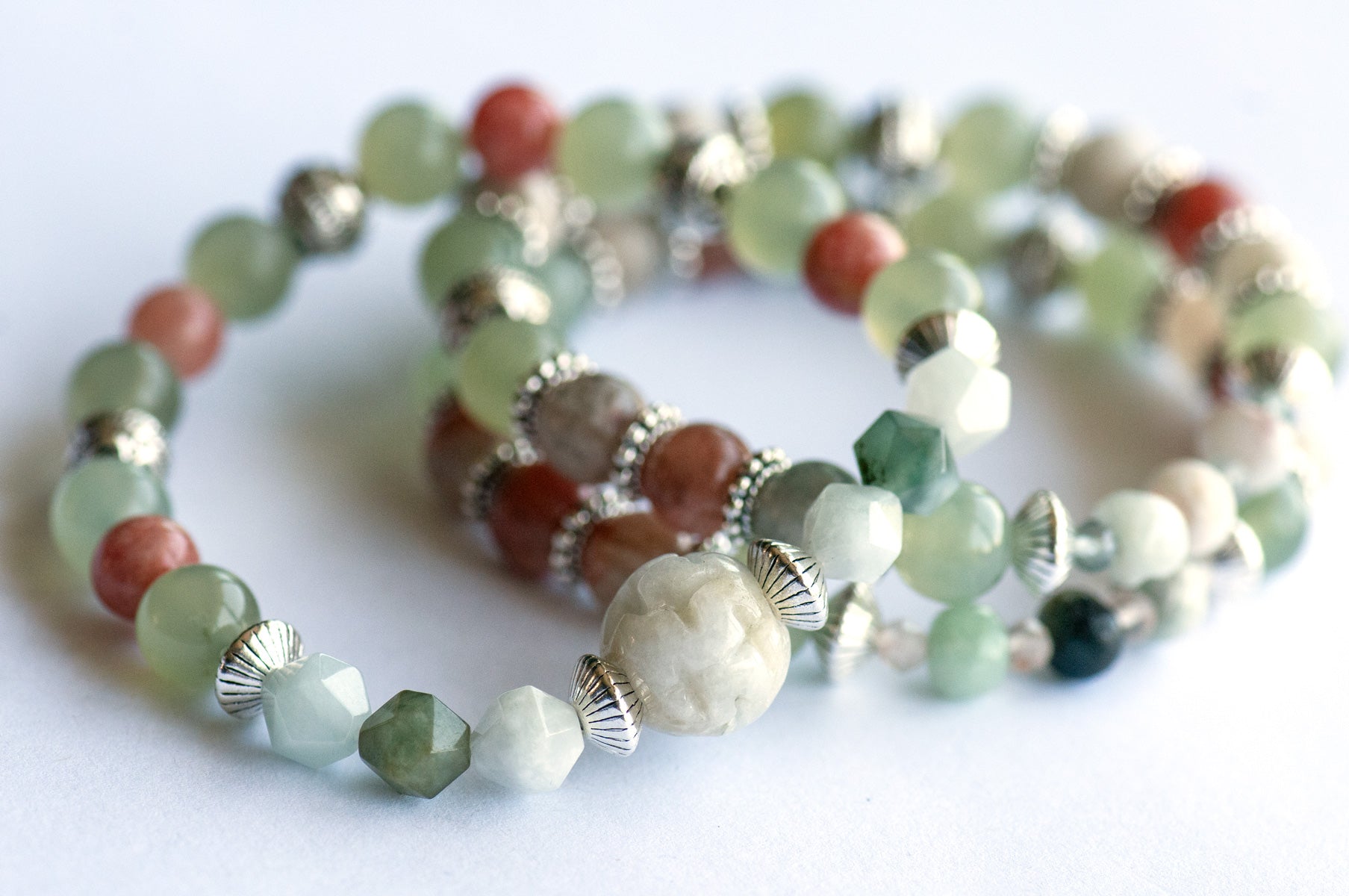The Fierce Acceptance bracelet set is handmade with Jade, Arusha Sunstone, and Sepentine in calming shades of green and orange.
