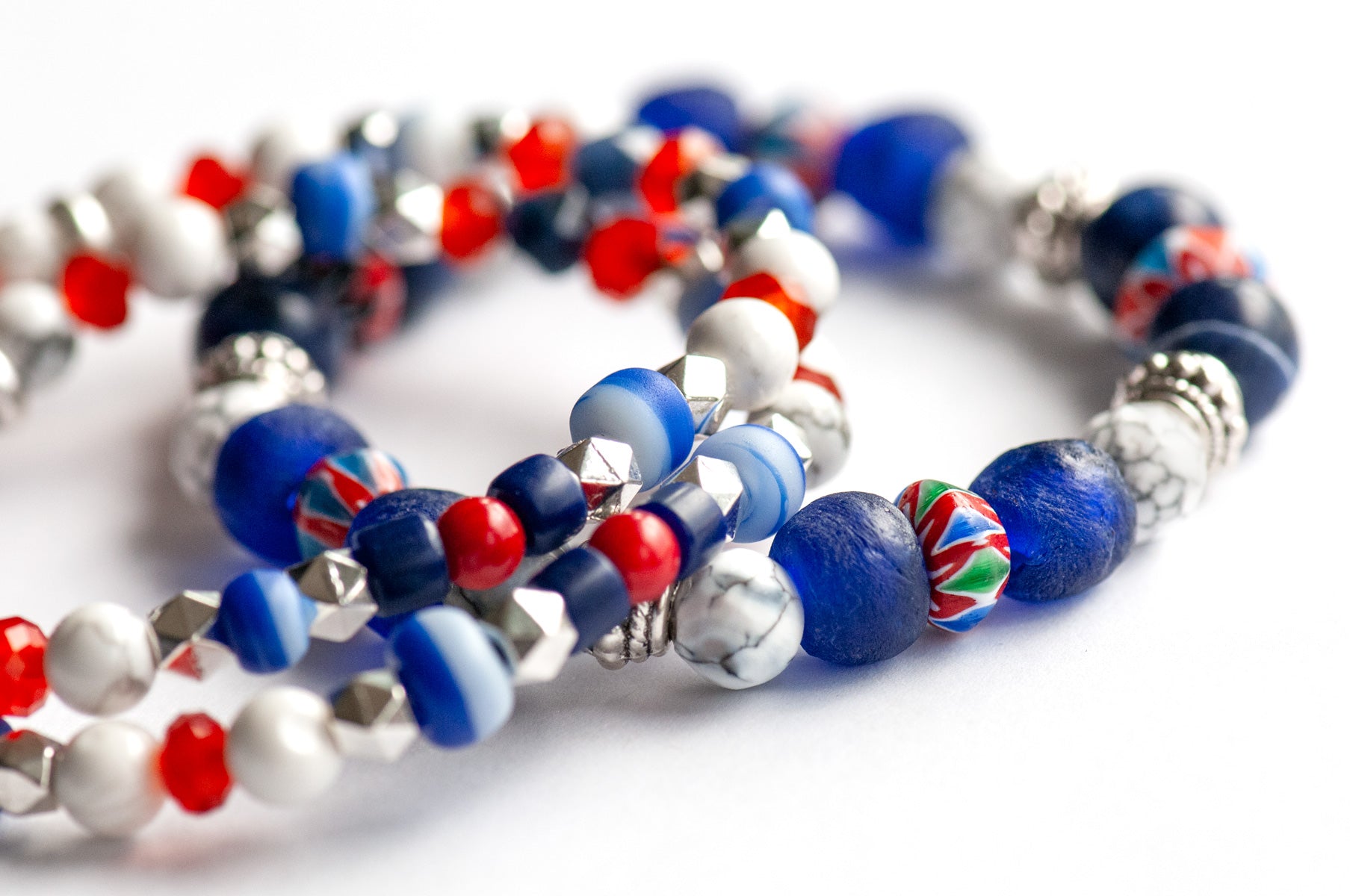 Vibrant Nautical Lynx bracelet set featuring red, white, and blue glass Chevron beads, cobalt blue recycled glass, AA-Grade Sodalite, Howlite rounds, and Tibetan silver spacers