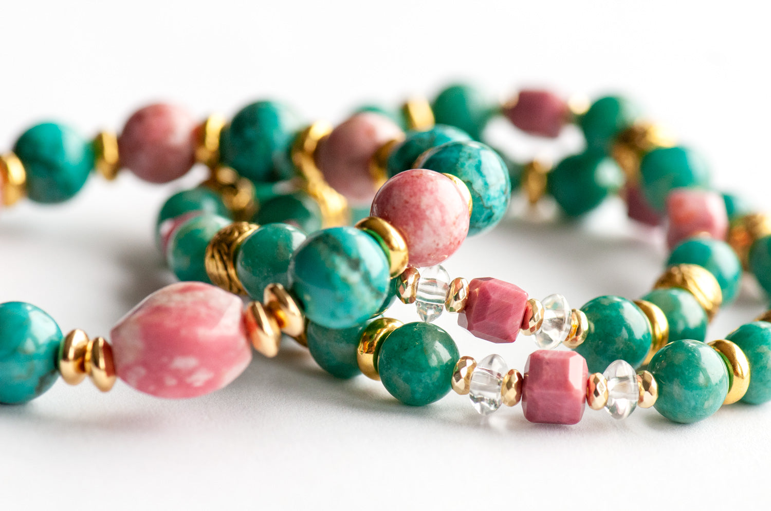 Fierce Compassion bracelet set featuring vibrant pink Thulite, turquoise Crazy Lace Calcite, dark turquoise Russian Amazonite, deep pink Rhodonite, crystal quartz, and gold accents