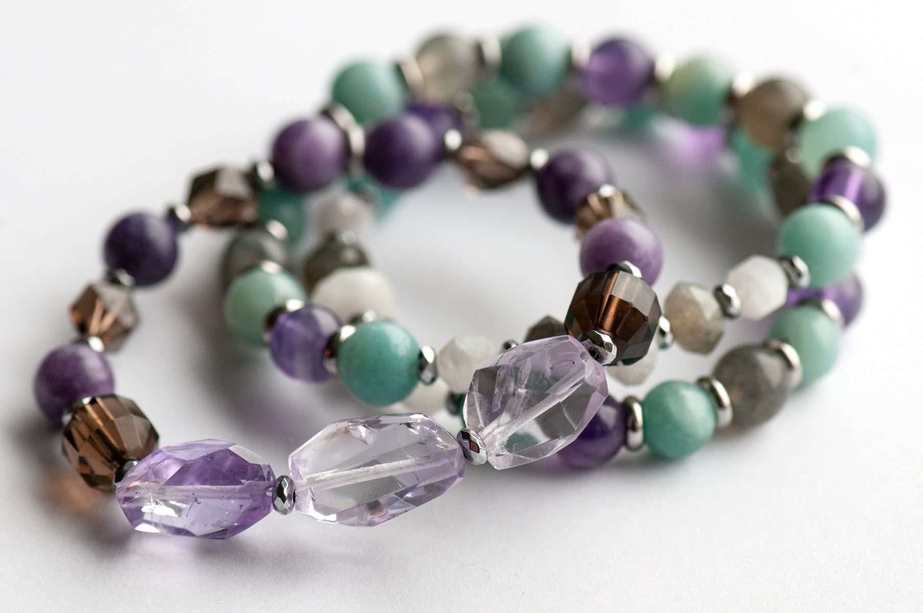 Fierce Healing bracelet set featuring lavender amethyst, smokey quartz, blue amazonite, deep purple amethyst, labradorite, and blue moonstone with hematite and stainless steel accents