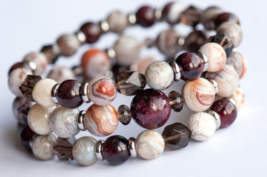 Fierce Strength bracelet set featuring red Garnet, Smoky Quartz rondelles, Laguna Lace Agate beads, and stainless steel spacers