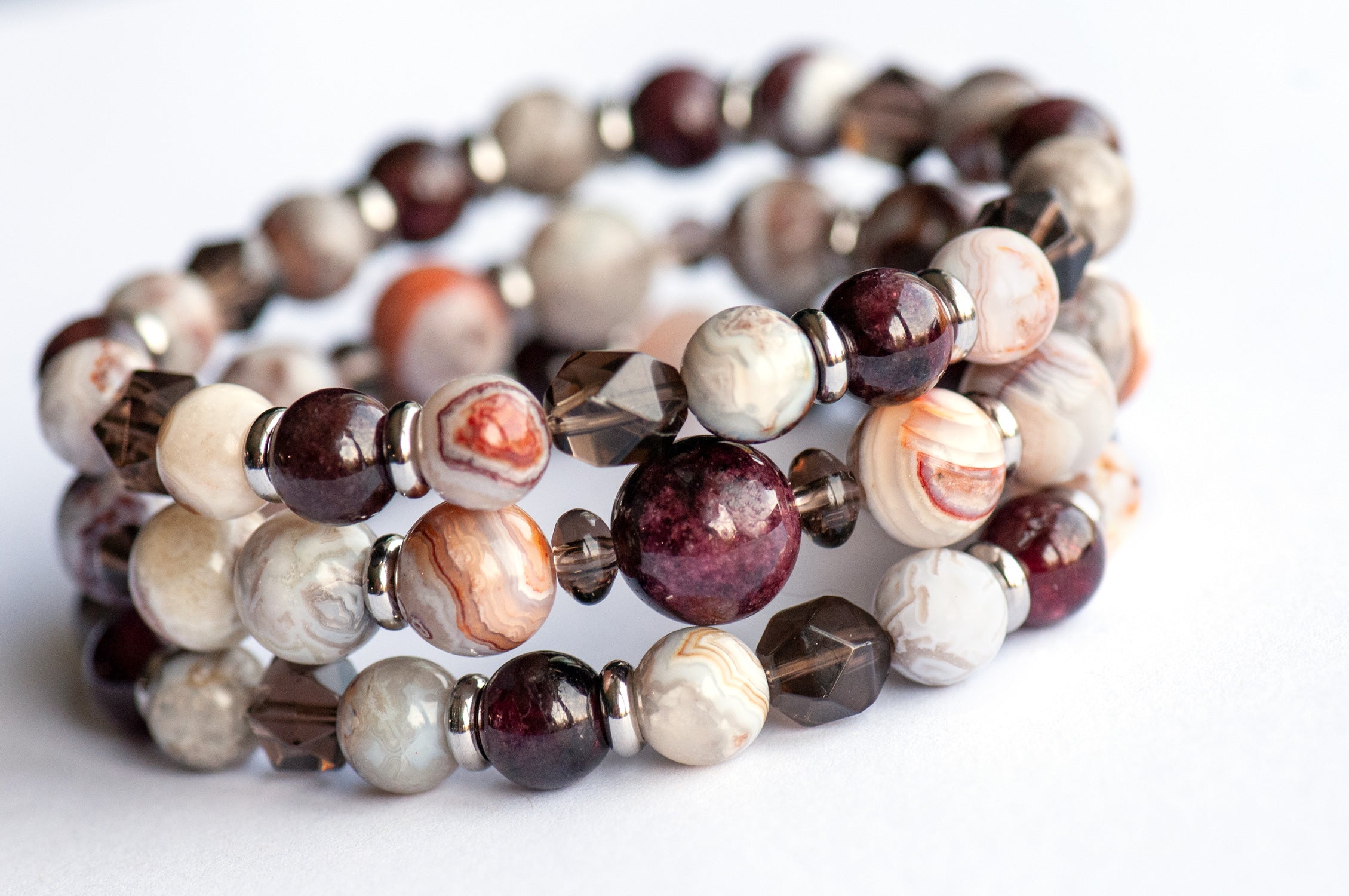 Fierce Strength bracelet set featuring red Garnet, Smoky Quartz rondelles, Laguna Lace Agate beads, and stainless steel spacers