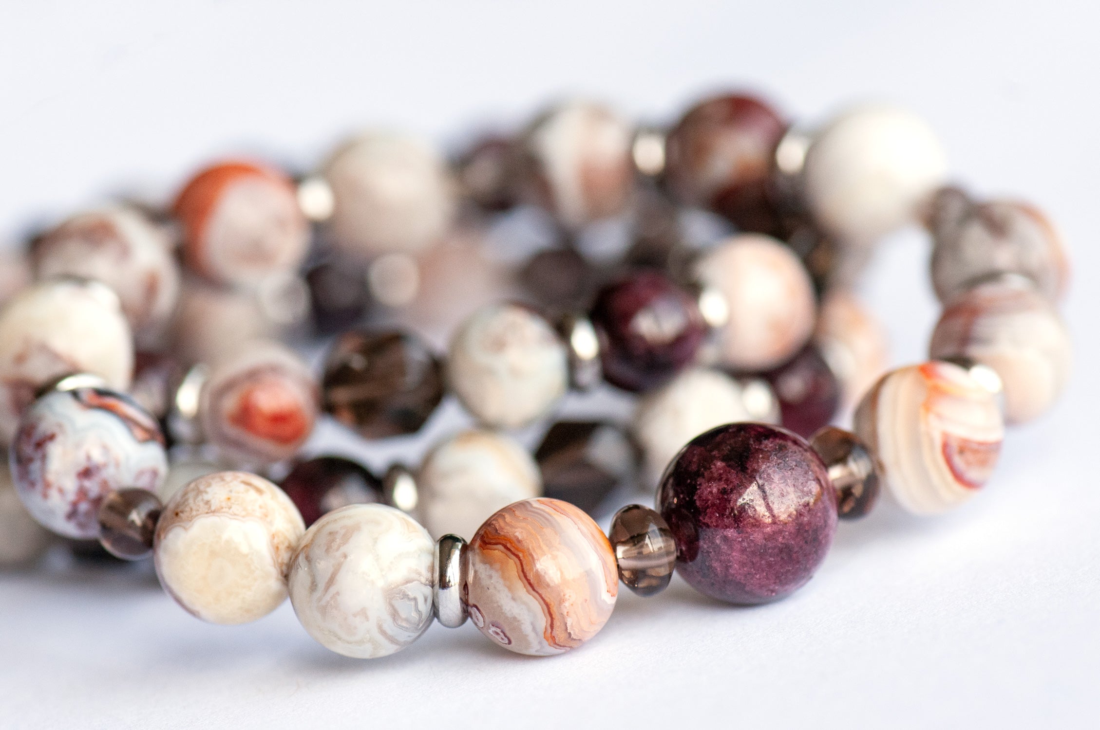 Fierce Strength bracelet set featuring red Garnet, Smoky Quartz rondelles, Laguna Lace Agate beads, and stainless steel spacers