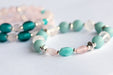 Fierce Affection bracelet set featuring Amazonite and Rose Quartz beads with turquoise white heart glass tube beads and silver-plated Hematite accents