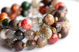 Abundant Lynx bracelet set featuring Rainbow Lodolite Quartz, White Kente Krobo beads, olive wood beads, and antique gold and vintage brass accents