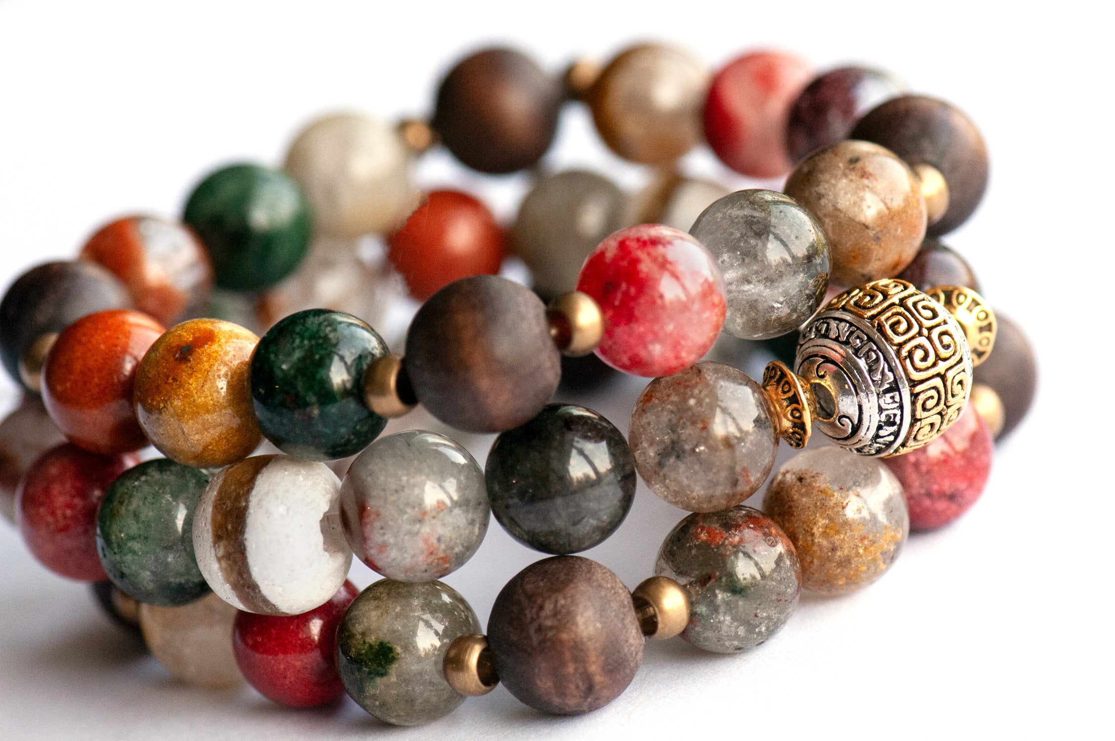 Abundant Lynx bracelet set featuring Rainbow Lodolite Quartz, White Kente Krobo beads, olive wood beads, and antique gold and vintage brass accents