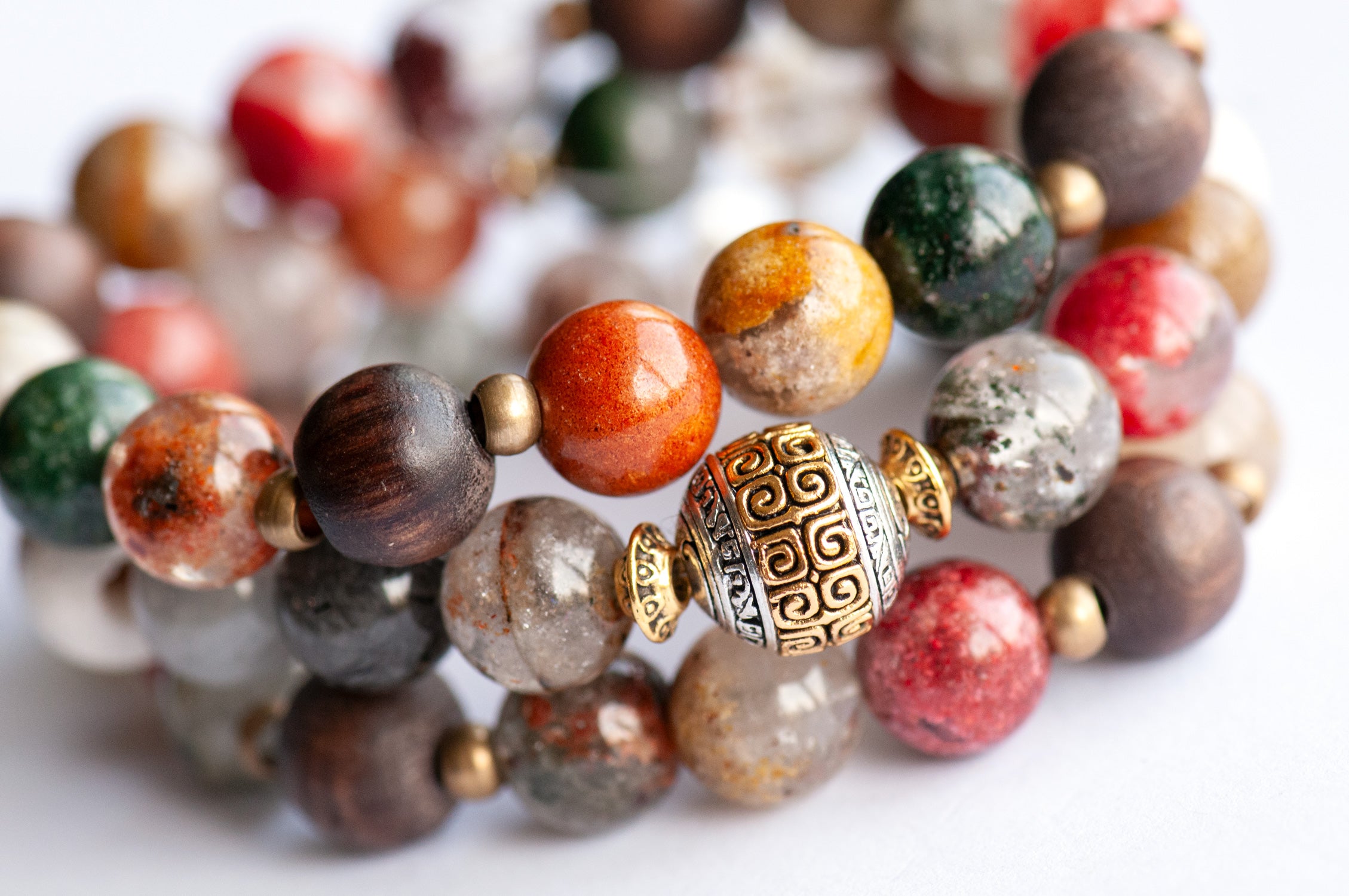 Abundant Lynx bracelet set featuring Rainbow Lodolite Quartz, White Kente Krobo beads, olive wood beads, and antique gold and vintage brass accents