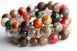 Abundant Lynx bracelet set featuring Rainbow Lodolite Quartz, White Kente Krobo beads, olive wood beads, and antique gold and vintage brass accents