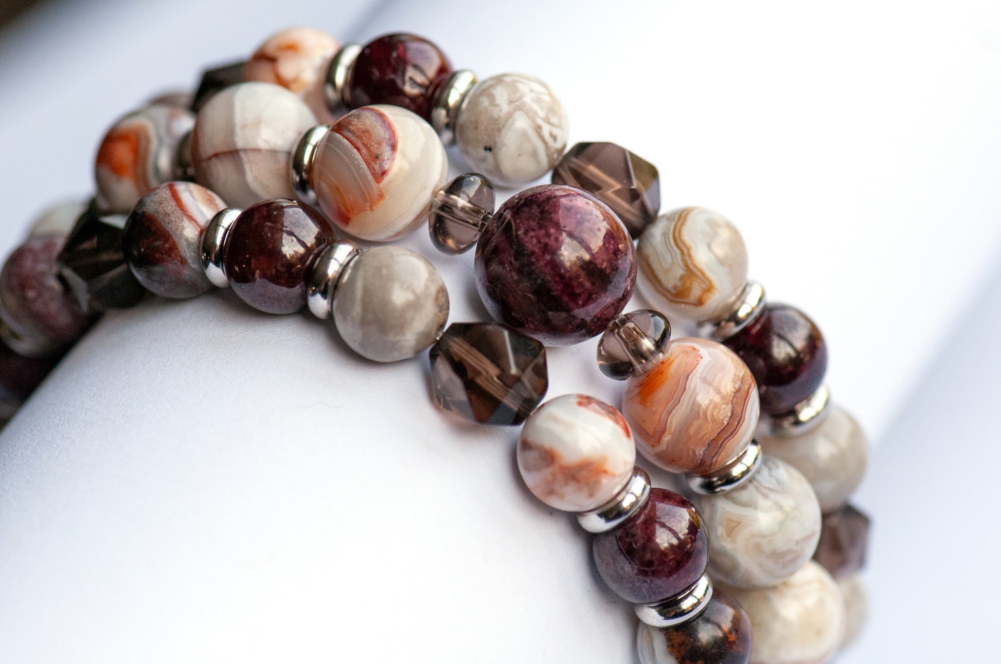 Fierce Strength bracelet set featuring red Garnet, Smoky Quartz rondelles, Laguna Lace Agate beads, and stainless steel spacers