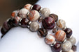 Fierce Strength bracelet set featuring red Garnet, Smoky Quartz rondelles, Laguna Lace Agate beads, and stainless steel spacers