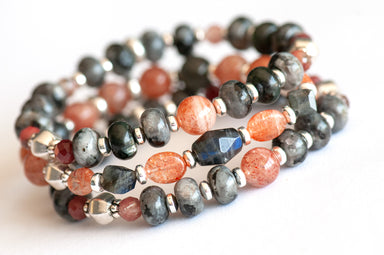 Fierce Balance bracelet set featuring hand-faceted Black Labradorite nugget, Sunstone ovals, Red Lazasine, Larvikite rondelles, and white silver Hematite spacers, part of the Fierce Friendship Collection.