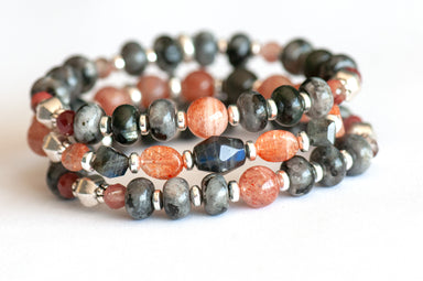 Fierce Balance bracelet set featuring hand-faceted Black Labradorite nugget, Sunstone ovals, Red Lazasine, Larvikite rondelles, and white silver Hematite spacers, part of the Fierce Friendship Collection.