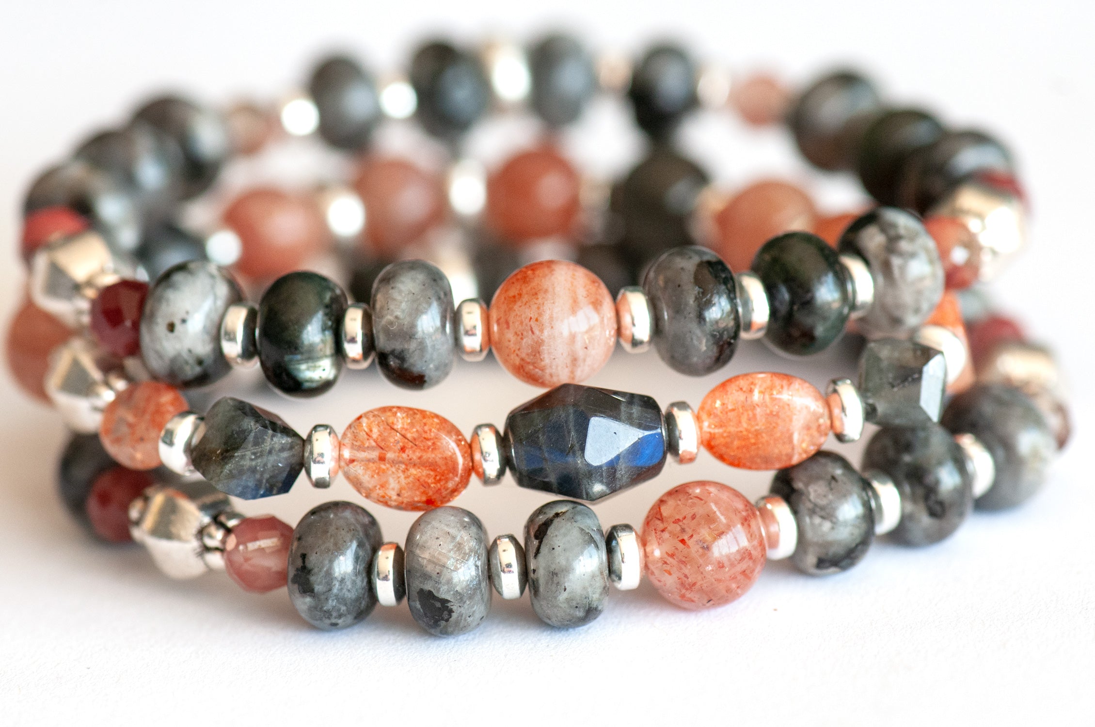 Fierce Balance bracelet set featuring hand-faceted Black Labradorite nugget, Sunstone ovals, Red Lazasine, Larvikite rondelles, and white silver Hematite spacers, part of the Fierce Friendship Collection.