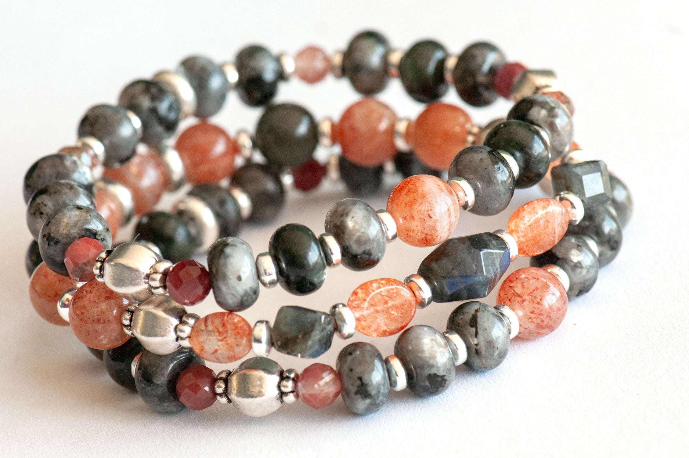 Fierce Balance bracelet set featuring hand-faceted Black Labradorite nugget, Sunstone ovals, Red Lazasine, Larvikite rondelles, and white silver Hematite spacers, part of the Fierce Friendship Collection.