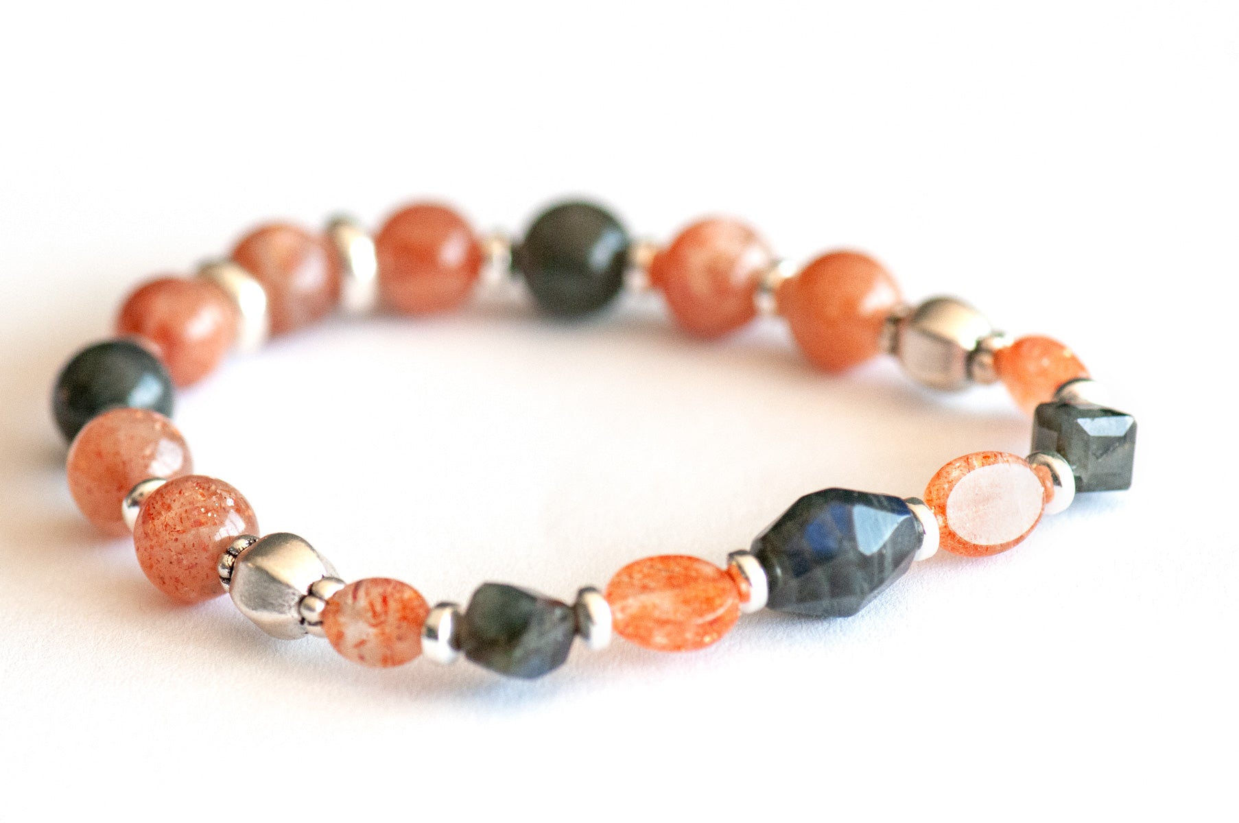 Fierce Balance bracelet set featuring hand-faceted Black Labradorite nugget, Sunstone ovals, Red Lazasine, Larvikite rondelles, and white silver Hematite spacers, part of the Fierce Friendship Collection.