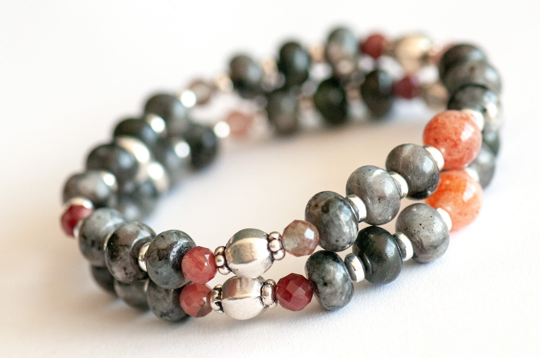 Fierce Balance bracelet set featuring hand-faceted Black Labradorite nugget, Sunstone ovals, Red Lazasine, Larvikite rondelles, and white silver Hematite spacers, part of the Fierce Friendship Collection.