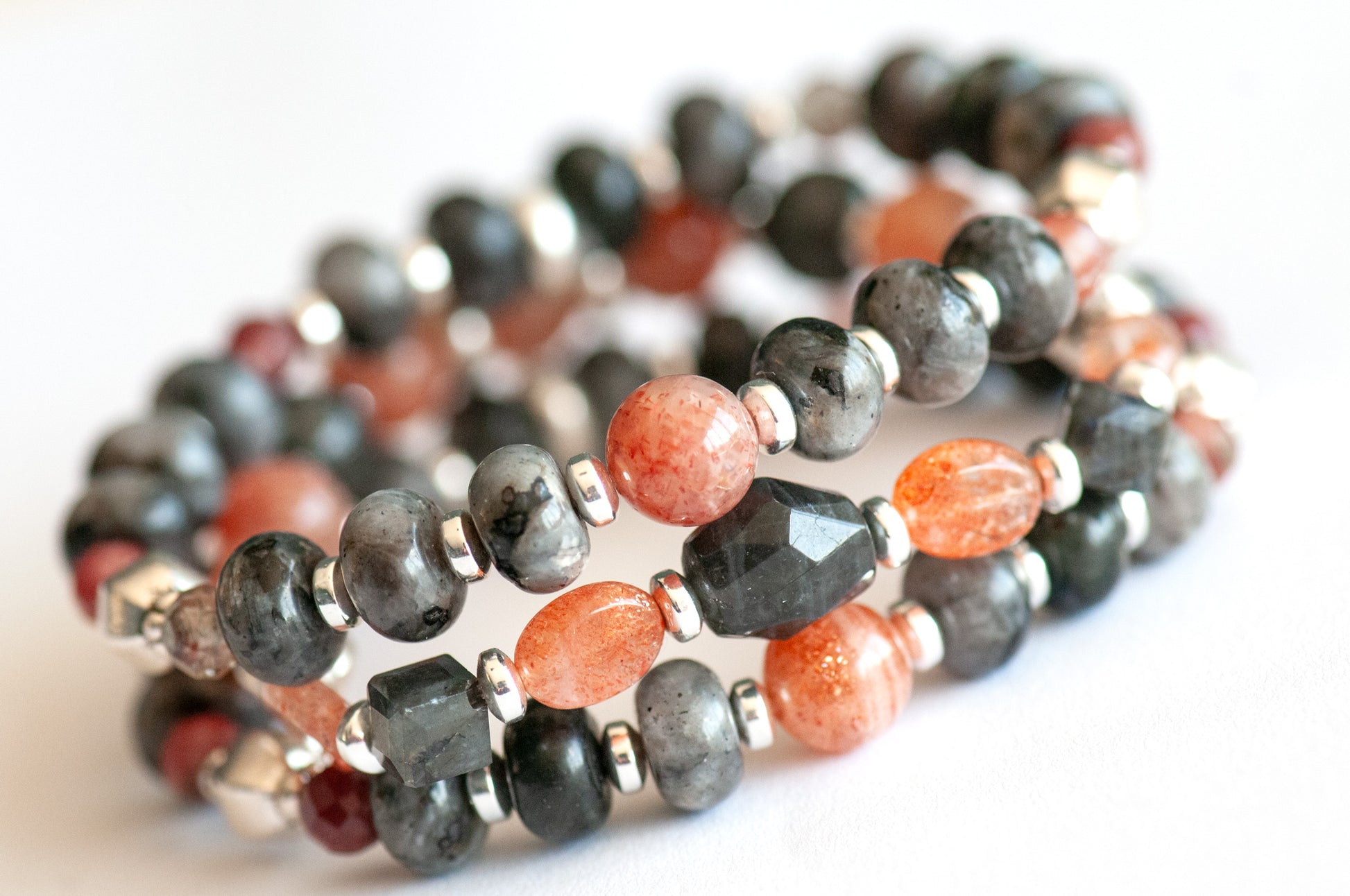Fierce Balance bracelet set featuring hand-faceted Black Labradorite nugget, Sunstone ovals, Red Lazasine, Larvikite rondelles, and white silver Hematite spacers, part of the Fierce Friendship Collection.