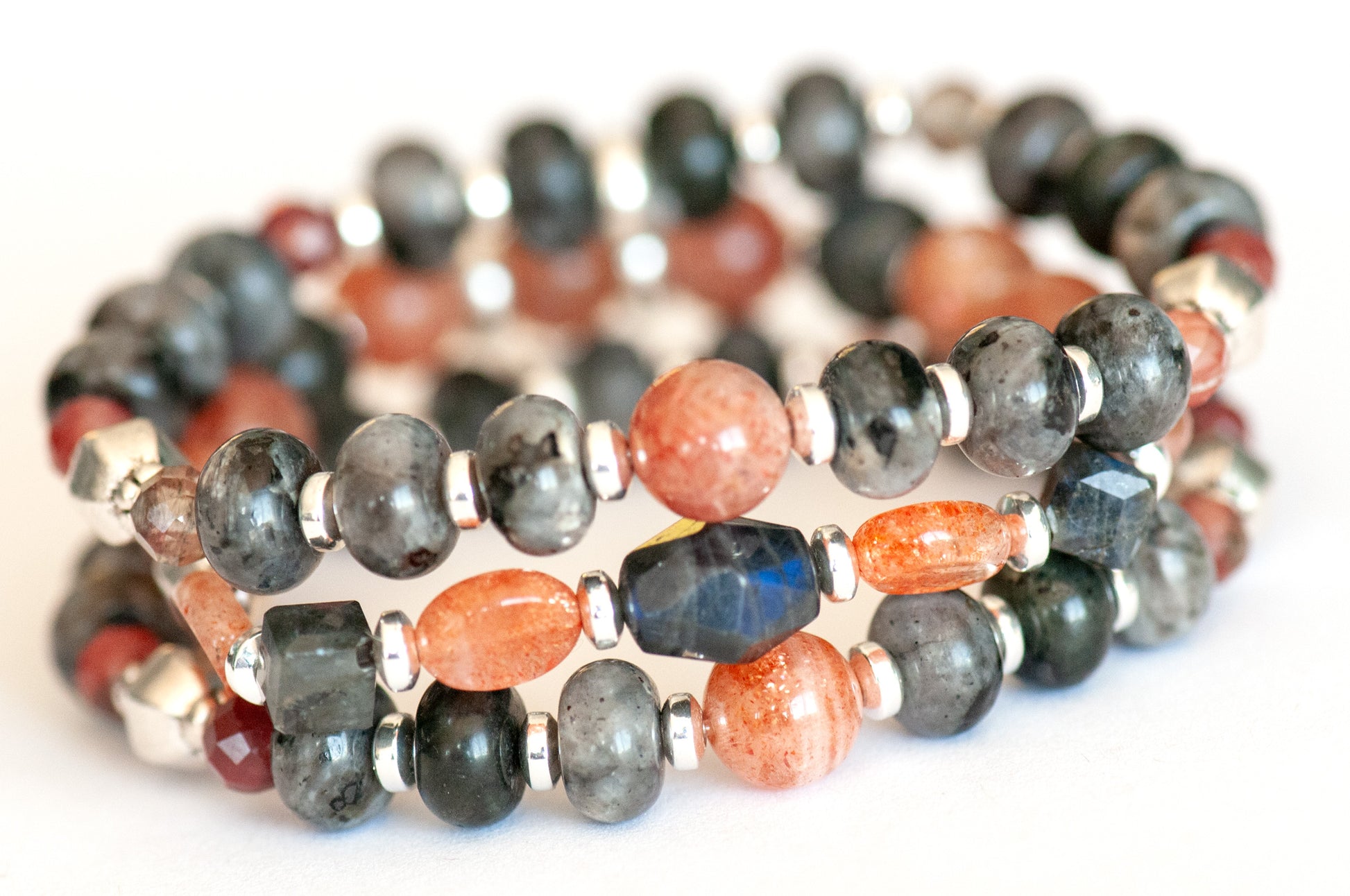 Fierce Balance bracelet set featuring hand-faceted Black Labradorite nugget, Sunstone ovals, Red Lazasine, Larvikite rondelles, and white silver Hematite spacers, part of the Fierce Friendship Collection.